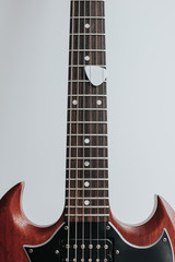 Crop shot o wooden guitar on white background.