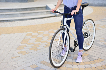 Fototapeta premium girl with a fixed bicycle, a place left for text.