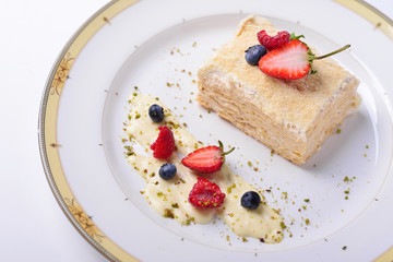 Napoleon cake with strawberries, raspberries, blueberries.