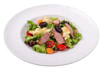 salad with duck breast, Physalis berries, jam from walnuts. Isolated
