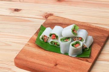 spring roll with vegetable on banana leaf wood floor background , Select focus  shallow depth of field.