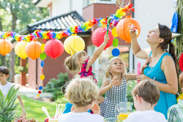 Kids party entertainer letting bubbles