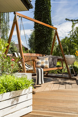 Villa patio with wooden garden swing
