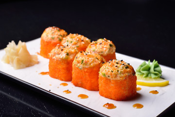 baked rolls, traditional Japanese cuisine. dark background