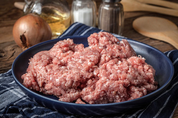 Minced meat on wooden background.