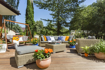 Spacious villa terrace with rattan furniture