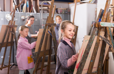 schoolgirls diligently training their painting skills during class at art studio
