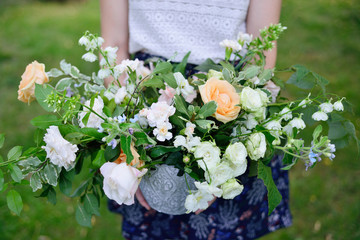 flower arrangement in silver bowl with pink and white roses