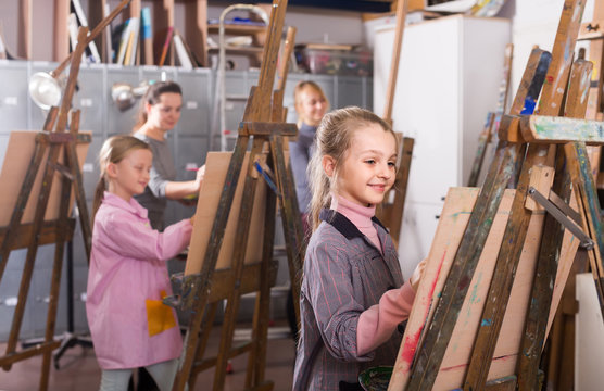 schoolgirls diligently training their painting skills during class at art studio