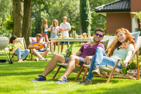 Young couple sitting on deckchairs