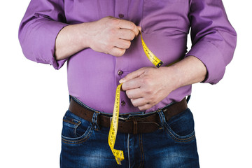 Thick mature man measuring his belly with a measuring tape, isolated on white background. Not proper nutrition.