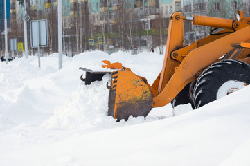  Snow clearing. Tractor clears the way after heavy snowfall.