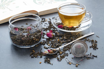 Obraz na płótnie Canvas Spilled green tea with a rose on stone table