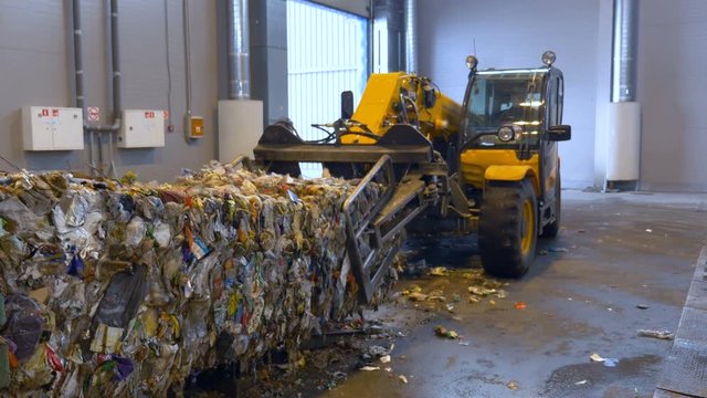 Lift truck, forklift loading a pile of trash on a truck. Special machinery working. 4K.