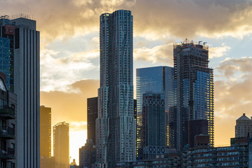 Sunset behind New York City Skyline Skyscrapers