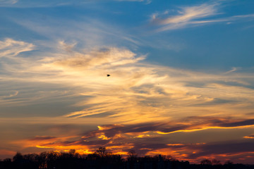 Wisps of clouds in the sky during a colorful sunset background