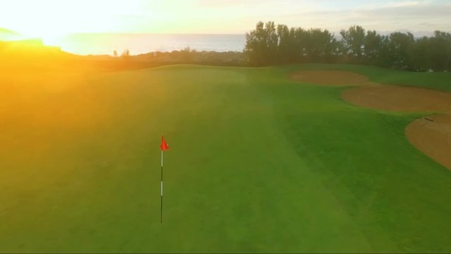 Fly around the golf pin on the sunset background