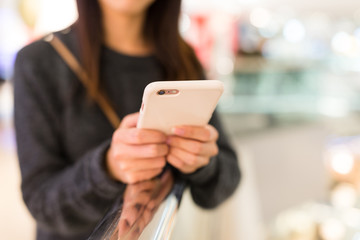 Woman using mobile phone for online