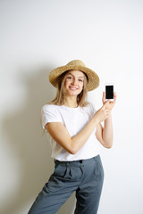Smiling happy young woman push phone button