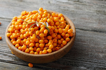 Fresh useful seabuckthorn in wood bowl