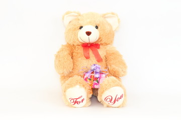 Brown teddy bear and gift boxes on a white background.