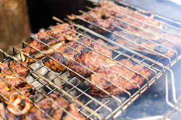 Meat on a grill with smoke