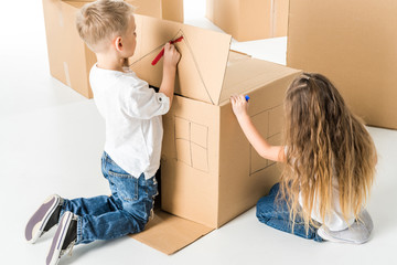 Kids drawing on cardboard box
