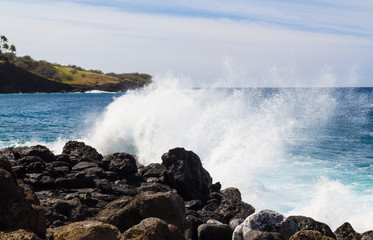 Spray from waves agains rocky shore in Hawaii 