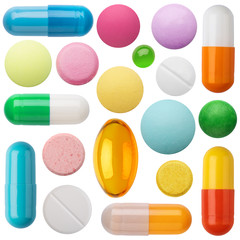 Many colorful pills and tablets isolated on white