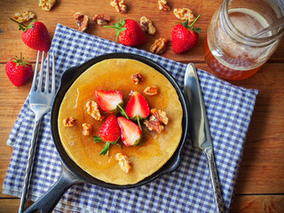 Pancakes with strawberry,nuts and honey for healthy breakfast