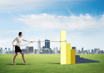 Businesswoman pulling arrow with rope and making it raise up