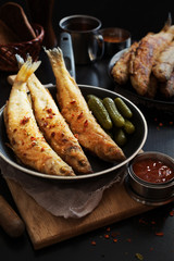 Fried smelt on a dark pan