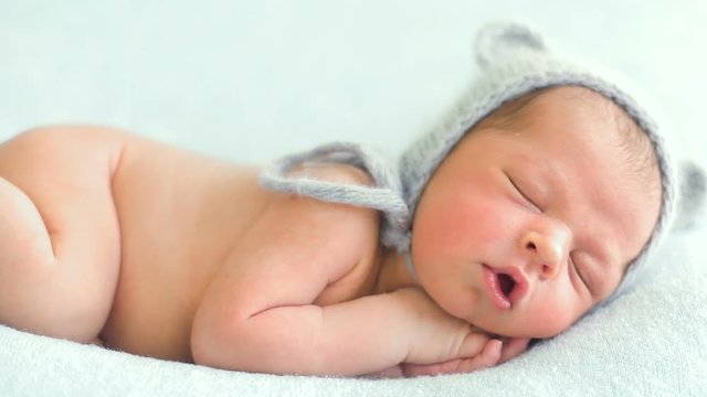 naked baby sleeping on the bed