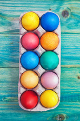 Fototapeta na wymiar Colorful Easter eggs on a blue wooden background