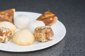 Delicious assortment of homemade Asian pastries. Samosas with a rose flower and banana balls