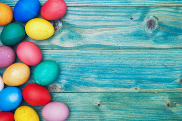 Colorful Easter eggs on a blue wooden background