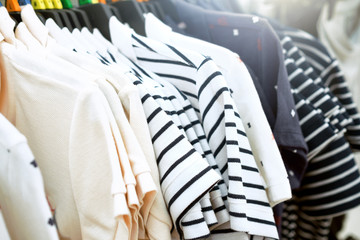 Clothes on clothes rail in clothing store