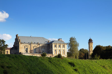 Fototapeta na wymiar Old Fortress, Fire Tower, grass and blue sky. Grodno, Belarus