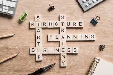 Conceptual business keywords on table with elements of game making crossword