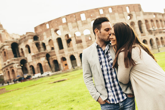 Loving couple in front of the Colosseum in Rome, Italy