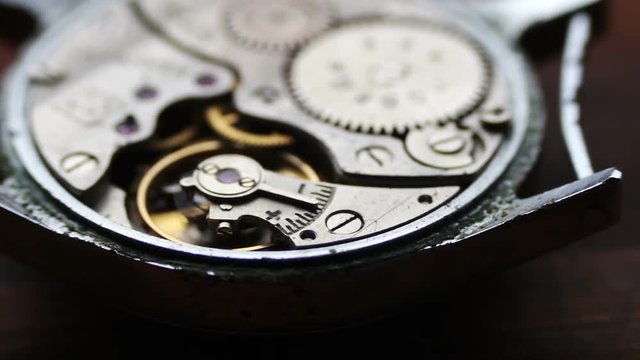 Old Stopwatch Mechanism On a stylish wooden background