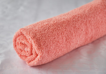 Twisted bath towel on white background