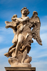 Fototapeta na wymiar Bernini's angel along the Holy Angel bridge in Rome