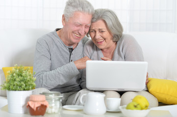 Beautiful elderly couple having breakfast 