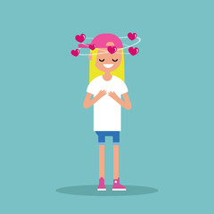 Young blond girl with hearts spinning around her head