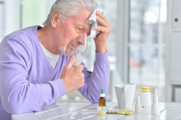 Elderly man doing inhalation