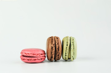 strawberry, chocolate and pistache macarons isolated