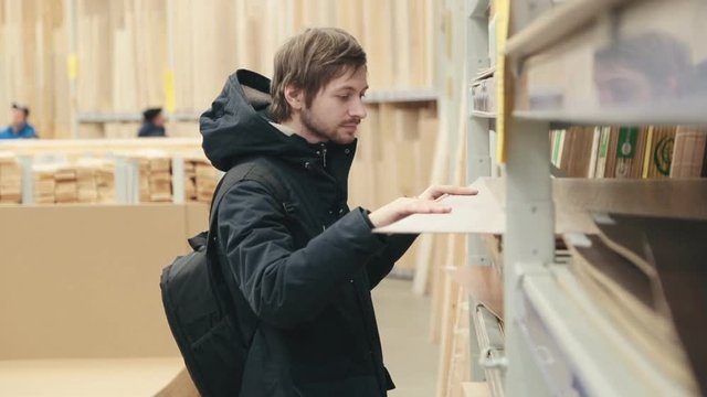 Man chooses products in the build supermarket.