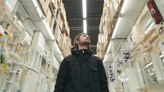 Man chooses products in the build supermarket.