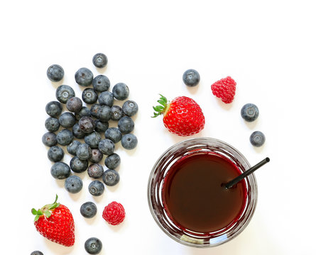 A glass of strawberries, raspberries, blueberries juice isolated on white.